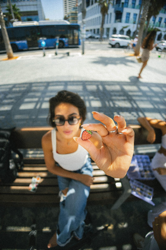 strawberry pin in hand
