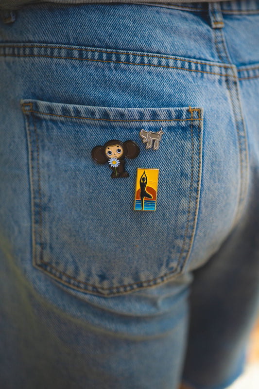 Blue denim jeans with pins on the back pocket