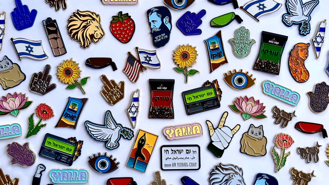 A colorful collection of PinPerfect enamel pins displayed together