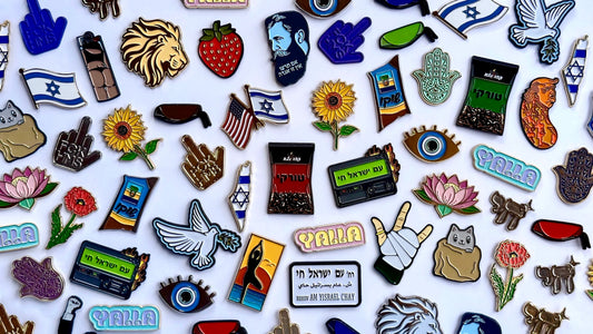 A colorful collection of PinPerfect enamel pins displayed together