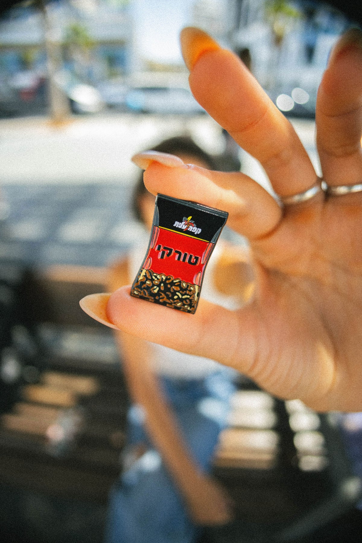 black coffee pin in hand