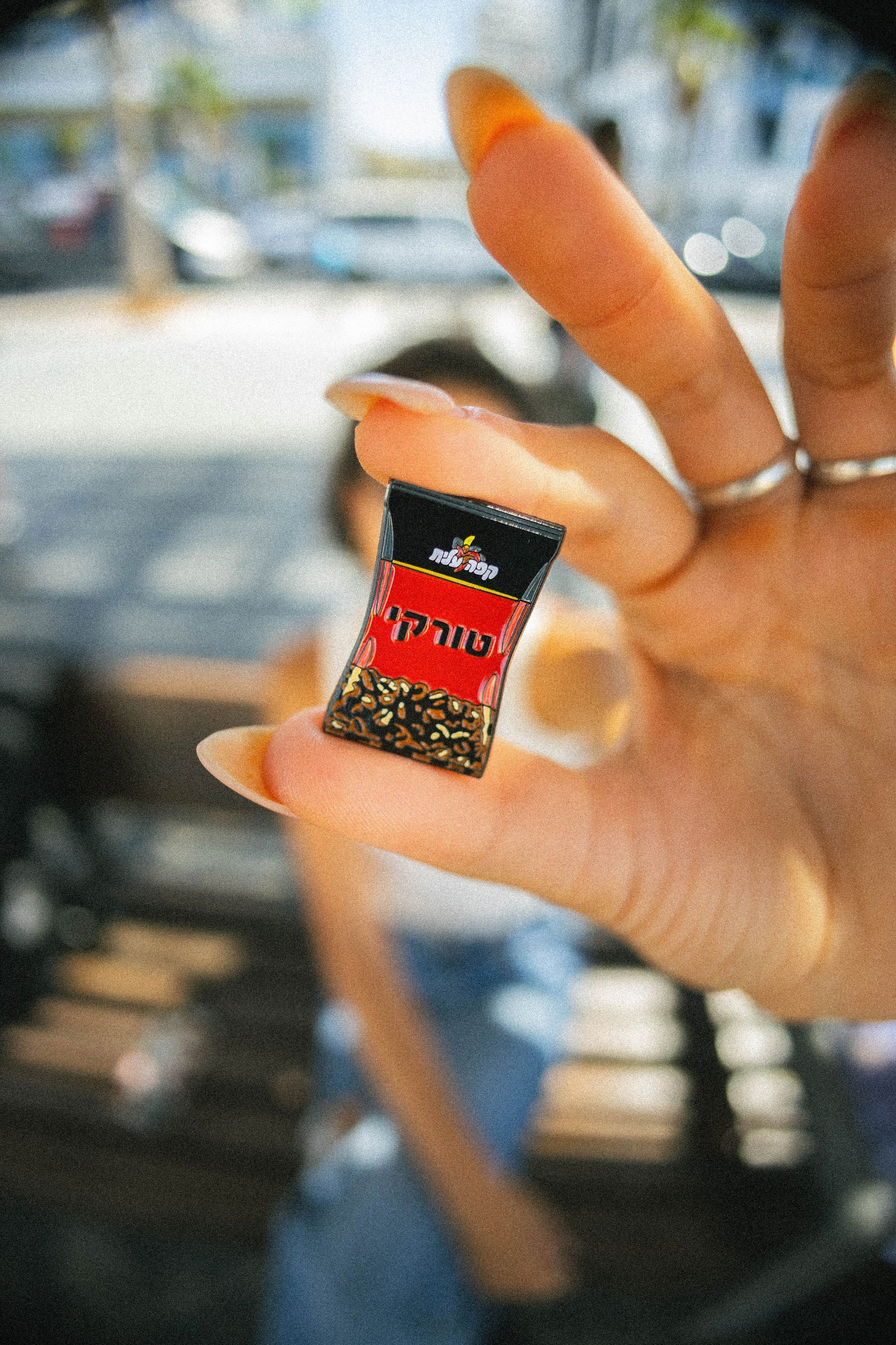 black coffee pin in hand