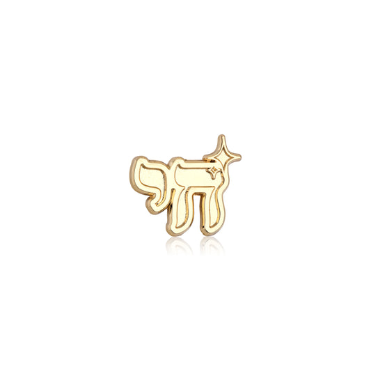 Gold chai-shaped pin on a white background
