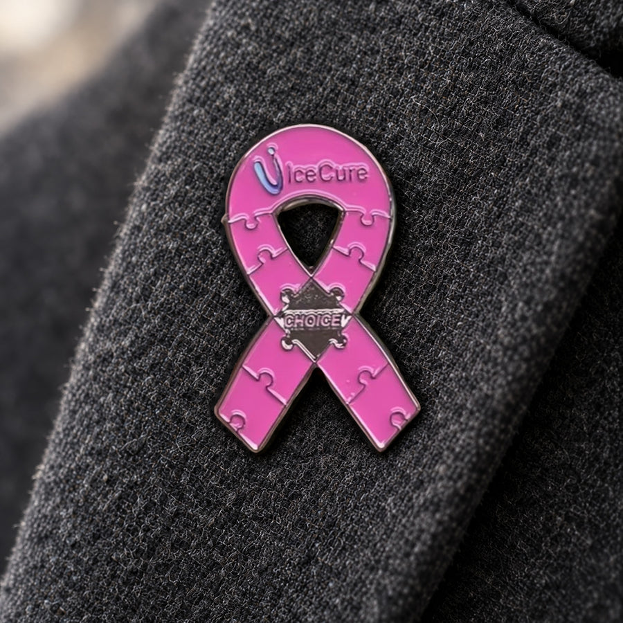 Pink IceCure awareness ribbon pin with puzzle details on black fabric