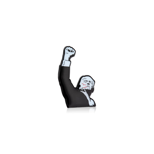 Figurine of Trump with a raised fist on a white background