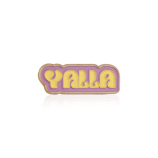 Enamel pin with 'Yalla' text on a white background