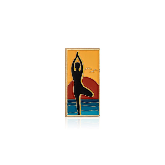 Enamel pin with a silhouette of a person in a yoga pose against a colorful background